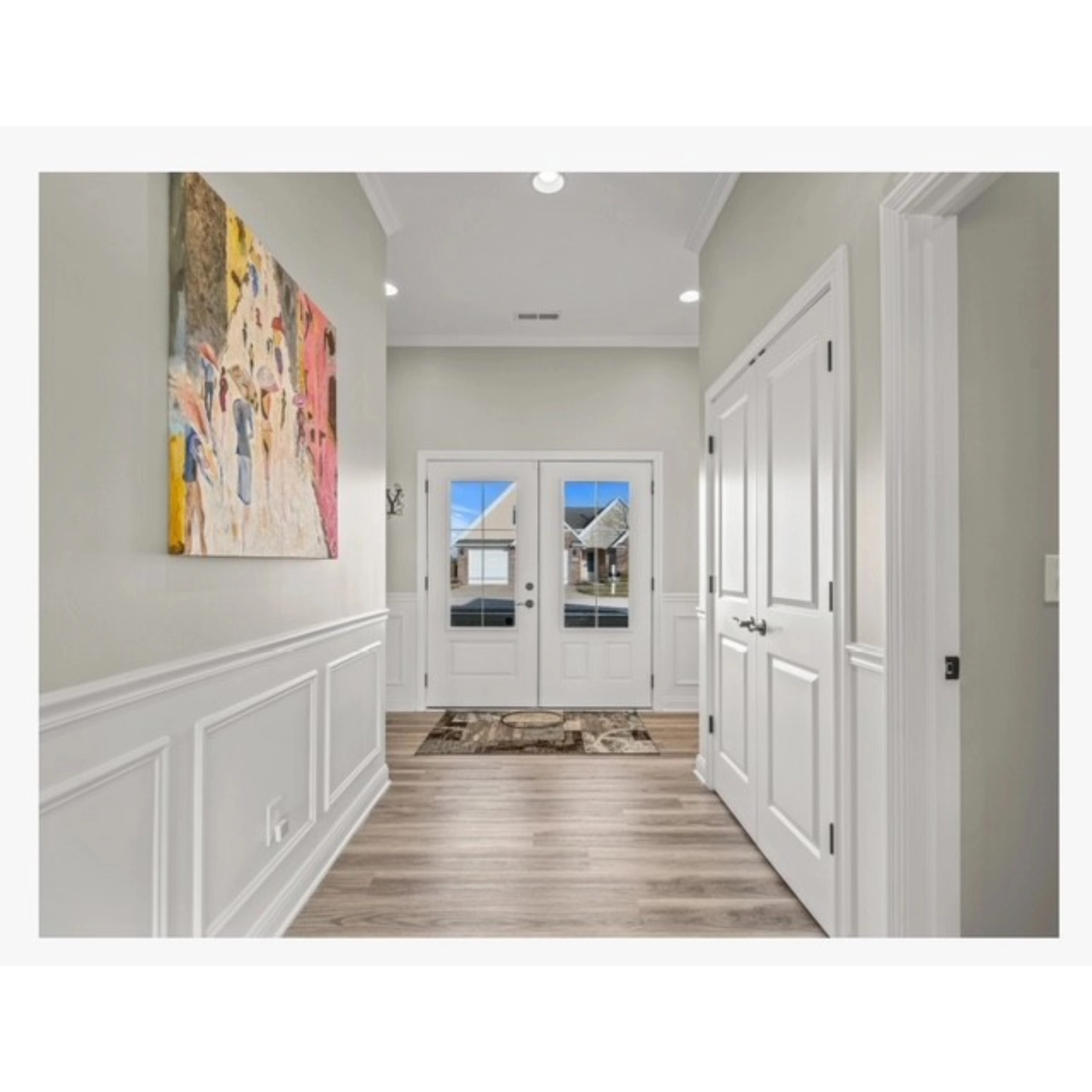 Modern entryway with white paneled walls